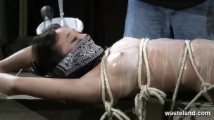 Bound naked slave gets covered with hot wax and given orgasms