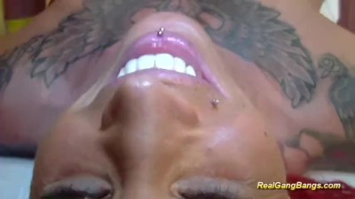 Busty tattooed babe in real gangbang