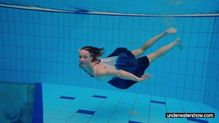 teen girl Avenna is swimming in the pool