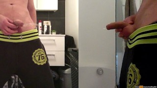 teen boy is urinating in the bathroom