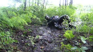 frogman quickly jerks off in shallow mud