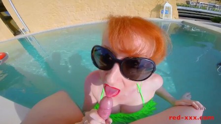 Red sucks and wanks a hard cock outside in the pool