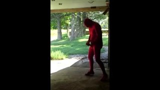 red zentai jerking off at garage door