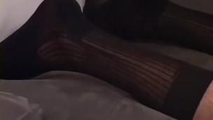 A tall hunk is jerking his cut cock while playing with socks