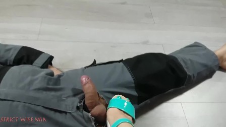 Footjob of slave's dick in green sandals
