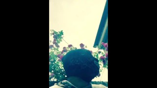 Masked ebony bbw smoking outside in garden and rubbing pussy