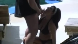Busty brunette sucks outdoors cock by the pool