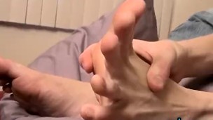 Attractive deviant Ryan slobbers on own feet while stroking
