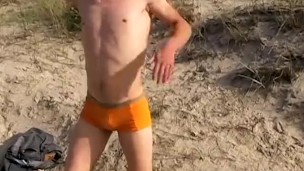Smooth jock cums hard on the beach after pissing solo