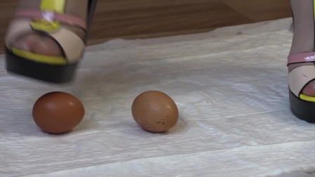 crashes eggs with high heels, mature lady in high-heeled shoes