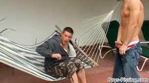 Handsome stud pisses on his twink lover from a balcony