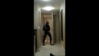 wearing wetsuit and fins shoot a quick load at open hotel door