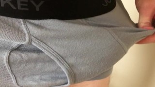 Guy pulls down his boxers and jerks off onto the floor