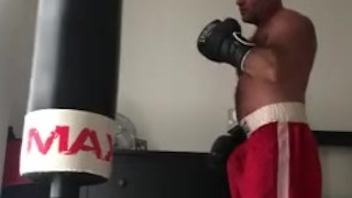 working the bag in red boxing trunks
