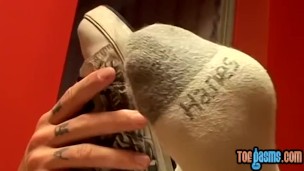 Thug jock Evan Heinze caressing socks in foot fetish solo