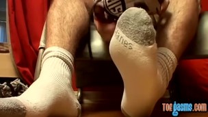 Thug jock Evan Heinze caressing socks in foot fetish solo