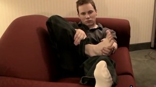 Young and handsome Tommy solo masturbates while showing his feet