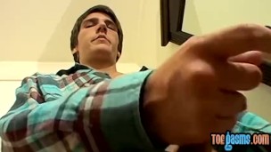Cute young man jerks off with his perfect feet in the front