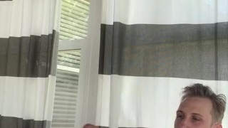 Skinny guy masturbating in a room full of windows