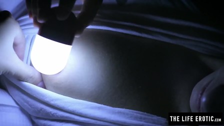 Sleepless girl rubs her clit at night with a hand held light