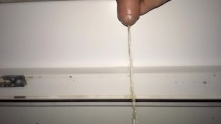Teen piss out of a window in a entrance of apartment building - Rainy night
