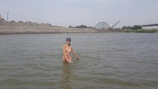 Girl bathes naked in the river and masturbates on the shore