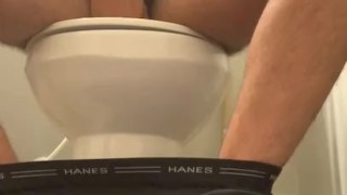 Soldier jacking off on toilet
