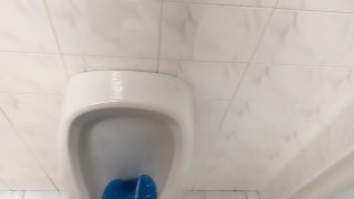 Peeing and moaning after pee desperation at the public urinal