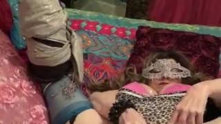 Masked girl uses toys tied up to rock music