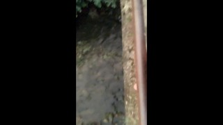 Twink piss from the bridge into the river