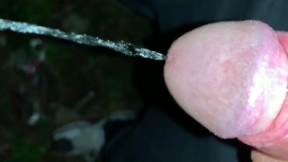 Slowmotion and close up - Unwashed uncut cock piss on the ground outdoor - long piss stream