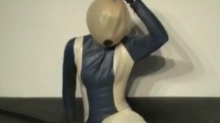 Girl With Transparent Latex Ballhood And Rubber Sheet Makes Breath Play