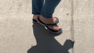 Female friend feet in flip flops coming to see me in public, in motion view