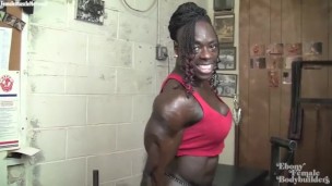 RIpped ebony female bodybuilder poses and flexes