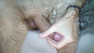 Hot stud jerks off and cums hard while taking a bath