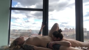Lesbians are making love on a balcony