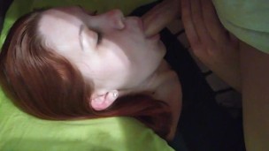 A young Russian red-haired girl is fucked in the mouth to the throat