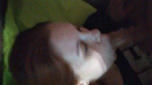 A young Russian red-haired girl is fucked in the mouth to the throat