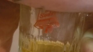 Bbw encouraged to pee more into glass