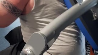 Tattooed muscular guy sweating in the gym 