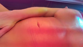 Oiled Up Hot Blonde MILF with Fake Boobs Plays with Clit in Public Tanning Bed 