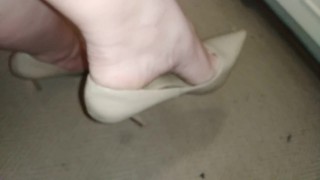 Shoeplay in tan heels. Dangling and dropping