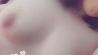 Playing with my tits. 