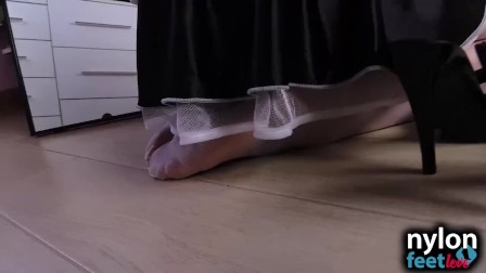 Horny maid in white stockings worships brunette nylon feet