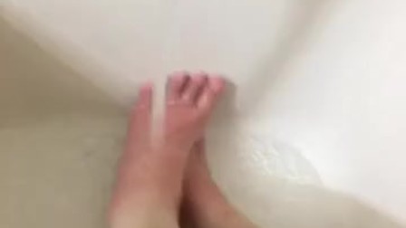 Girl washing sore feet and ankles after working long shift