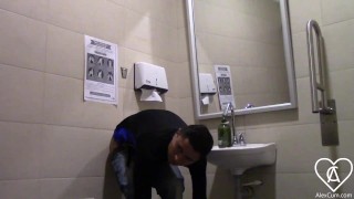 Young man enters the bathroom of a supermarket and leaves it full of milk