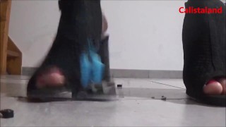 Crushing toy cars with black heels