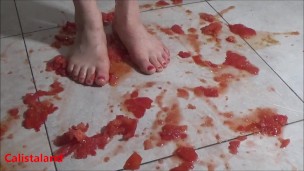 Several tomatoes are crushed under my wonderful bare feet