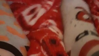 Tiny feet in mix match socks rubbing blanket
