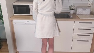 Desperate girl has to pee while washing dishes